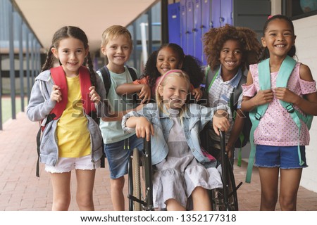 [[stock_photo]]: Front View Of Happy Smiling Mixed Race Disabled Schoolboy Talking On Mobile Phone In Corridor At Ele