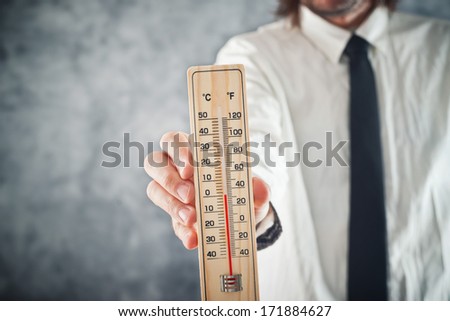 Stock fotó: Businessman Holding Thermometer With Temperature On Zero Value