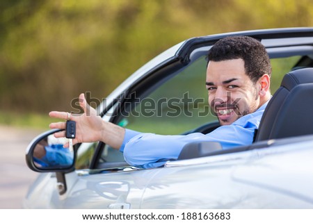 Stock photo: Young Latin American Driver Holding Car Keys Driving His New Car