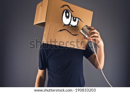 ストックフォト: Man With Cardboard Box On His Head Using Tin Can Telephone