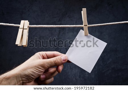 Stockfoto: Hand Picking Blank Note Paper Attached To Rope With Clothes Pins