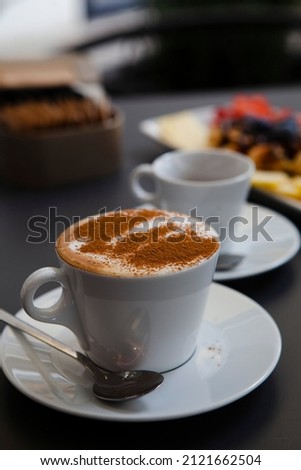 Stock fotó: Espresso In A Short Glass With Coffee Beans And Cinnamon From Side