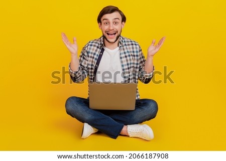 Foto stock: Amazed Shocked Man In Plaid Shirt Holding And Using Laptop