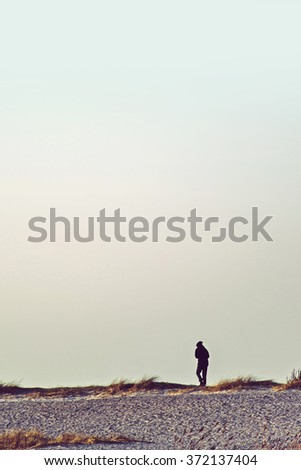 Foto stock: Unrecognizable Person Walking On Wasteland Horizon