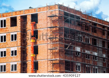 ストックフォト: Scaffolding Around New Unrendered Building At Construction Site