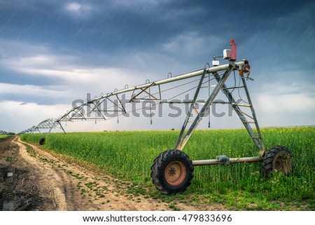 [[stock_photo]]: Irrigation In Oilseed Rape Field On Rainy Day