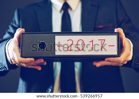 Imagine de stoc: Businessman Holding 2017 Document Ring Binder Folder