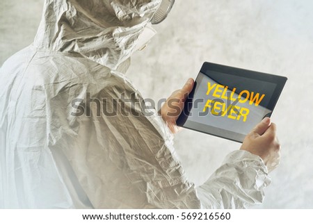 Stockfoto: Scientist Using Tablet To Get Informed About Yellow Fever Diseas