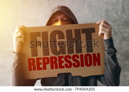 Foto stock: Hooded Activist Protestor Holding Fight Repression Protest Sign