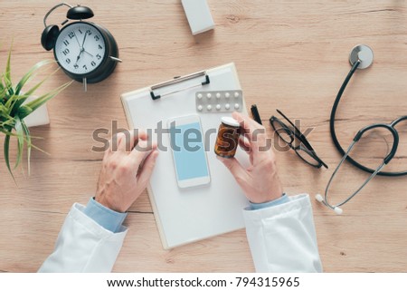 Stock fotó: Male Doctor Holding Unlabeled Bottle Of Various Pills And Medica