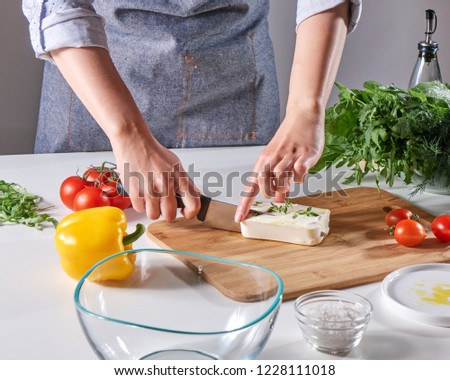 Womans Hands Cut The Cheese With The Sprouts On The Wooden Board On The Kitchen Table With Differen Сток-фото © artjazz
