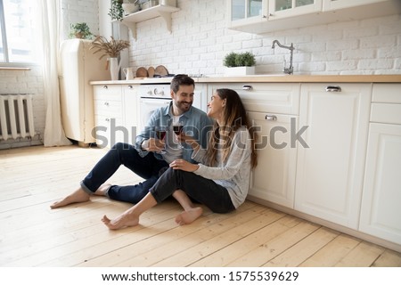 Foto d'archivio: Cheerful Couple In Love Having A Good Time On The Floor In The Apartment