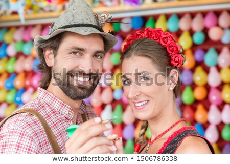 Stockfoto: Man Throwing Darts As Entertainment On Traditional Bavarian Fair