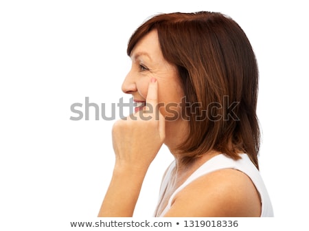 Foto stock: Profile Of Senior Woman Pointing To Eye Wrinkles