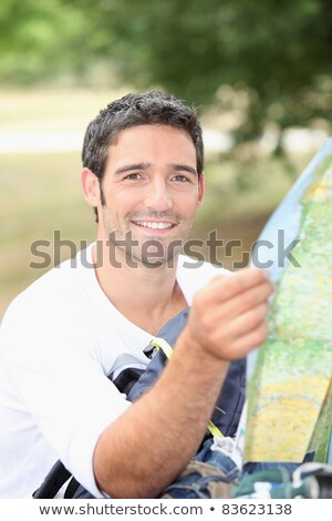 Stockfoto: 30 Years Old Man Watching A Map In The Forest