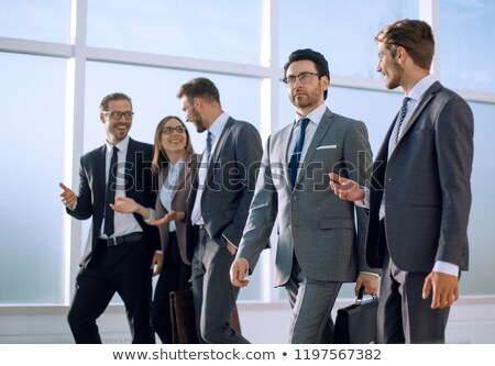 Stock photo: Young Woman In Business Suit Is Moving Forward