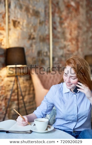 Happy Businesswoman Talking On The Phone And Writing In Organize Сток-фото © Pressmaster