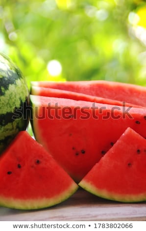 Foto d'archivio: Watermelon Cross Section Slice On Wooden Table
