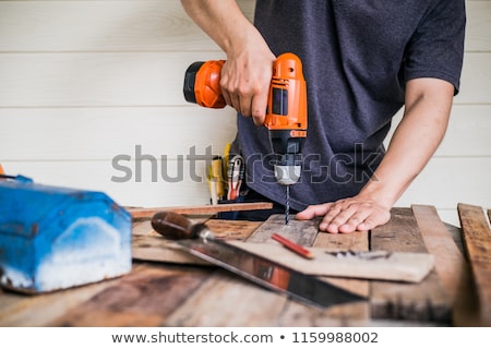 Foto stock: Carpenter Handyman Using Electric Drill
