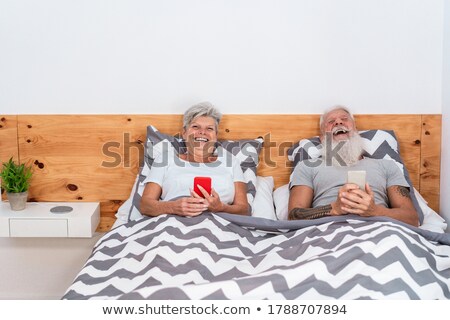 Paar im Bett lachend Stock foto © DisobeyArt