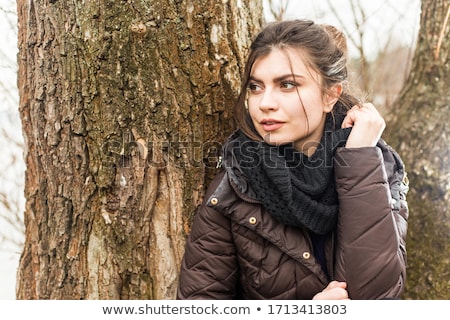 Stock fotó: Stylish Young Woman In Winter Clothes Standing In Winter Forest