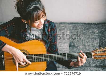 Foto stock: Woman Playing Guitar