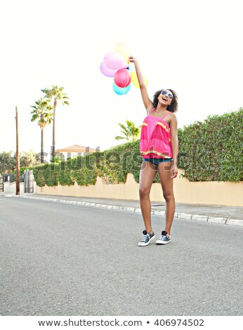 Сток-фото: Woman With Balloons On Suburban Street