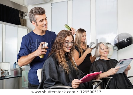 Imagine de stoc: Man Stylist Working With Woman In Beauty Salon