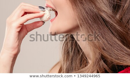 Stock fotó: Brunette Lady With Bunch Of Red Roses Eating Sweet