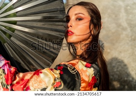 Stock photo: Woman Wearing Traditional Asian Clothing With A Large Fan