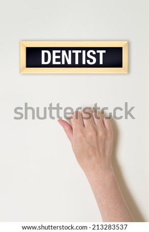 Stockfoto: Female Hand Is Knocking On Dentist Door