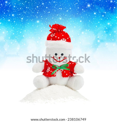 [[stock_photo]]: Smiling Generic Christmas Snowman Toy Sitting On Snow Pile