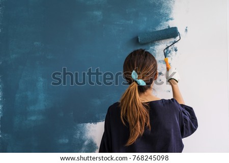 Stock photo: Young Woman Painting Wall