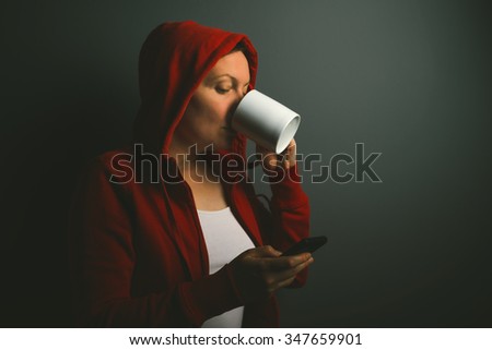 Stock fotó: Beautiful Red Hooded Woman Drinking Coffee And Sending Text Mess