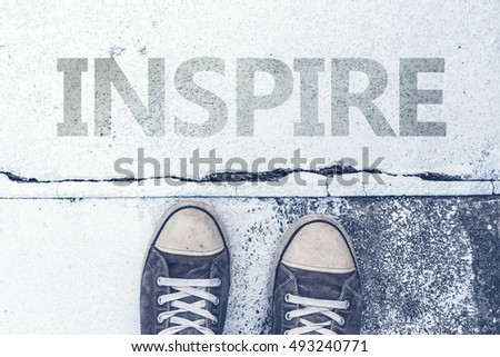 Stock fotó: Sneakers Standing Over Inspire Title On Pavement