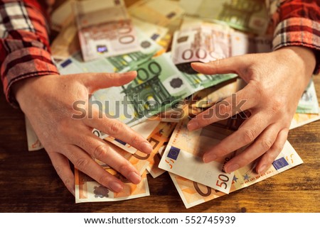 Stock photo: Greedy Hands Withdrawing Pile Of Euro Banknotes Cash