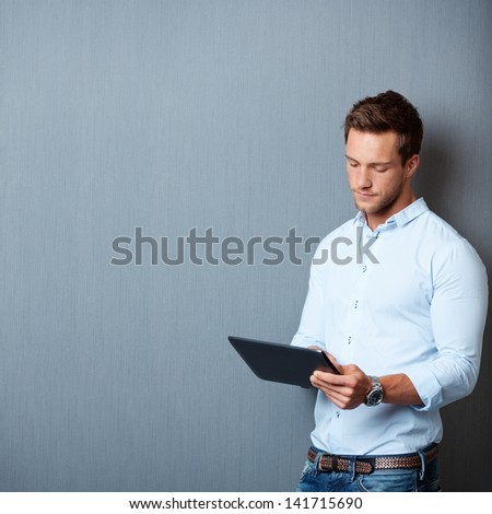 Foto stock: Handsome Businessman Working With Tablet Computer Isolated On Wh