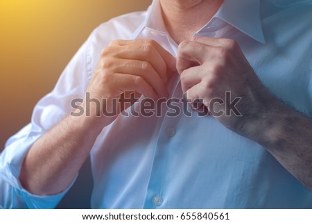 Stockfoto: Businessman Buttons White Shirt With Roll Up Tuck Sleeves