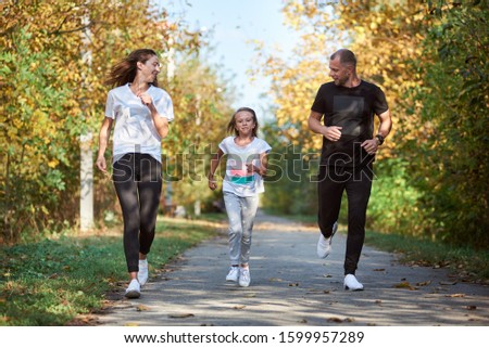 Zdjęcia stock: Parents With Children Sport Running Together Outside