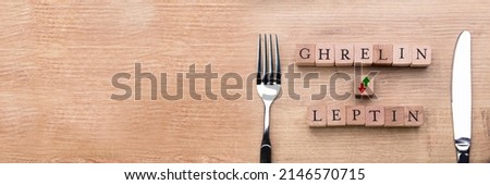Stockfoto: Ghrelin And Leptin Words On Wooden Desk
