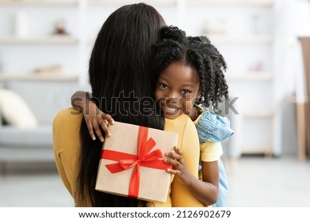 Zdjęcia stock: Indoor Shot Of Pleasant Looking Female Mother Embraces Her Small Kid Sit On Window Sill Near Bed E