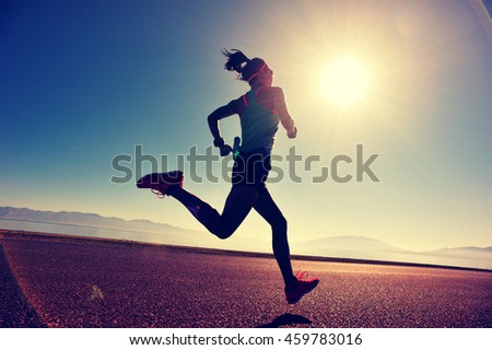 Stok fotoğraf: Woman Runner Training Cardio Running By The Ocean On The Beach Morning Workout Copyspace On Blue W