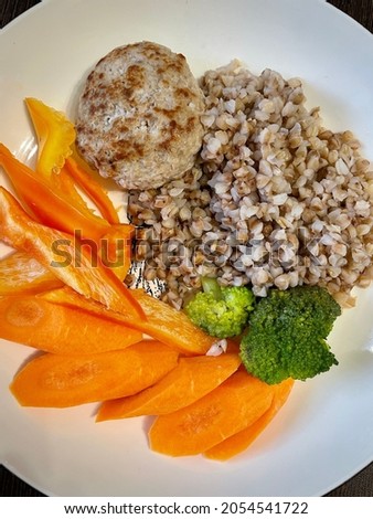 Stok fotoğraf: Large Chicken Cutlet With Sauce And Buckwheat