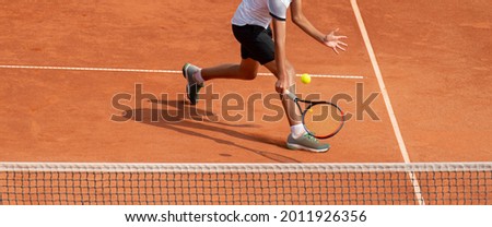Foto d'archivio: Male Tennis Player In Action On The Clay Court On A Sunny Day