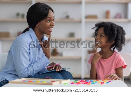 Zdjęcia stock: Side View Of Pretty Young African American Female Doctor Measuring Blood Pressure With Sphygomanomet