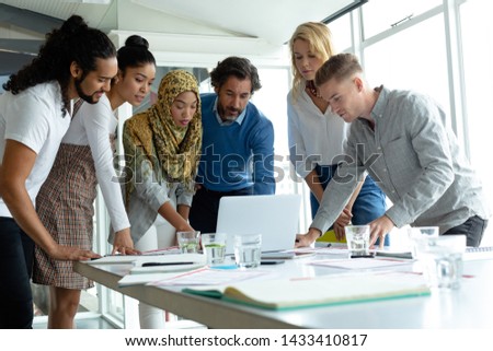 [[stock_photo]]: Front Of View Of Diverse Business People Interacting With Each Other At Table After A Seminar In Off