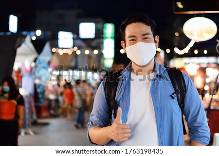 Stock photo: Young Man Tourist In Medical Mask On Walking Street Asian Food Market Tourists Fear The 2019 Ncov Vi