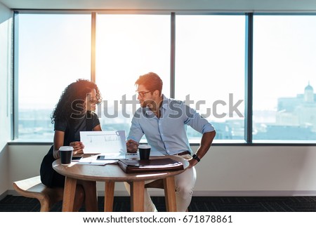 ストックフォト: Woman Looking Over Paperwork With Colleagues