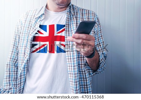 Stockfoto: Man With United Kingdom Flag On Shirt Using Mobile Phone