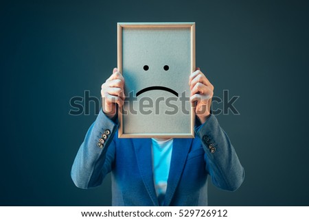 Stockfoto: Businesswoman Is Pessimistic Holding Smiley Emoticon Over Face